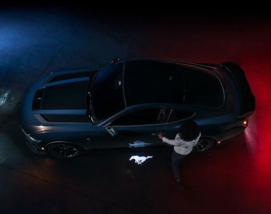 2024 Ford Mustang® Dark Horse™ model with a driver approaching the vehicle | Pfeifle Ford in Wishek ND