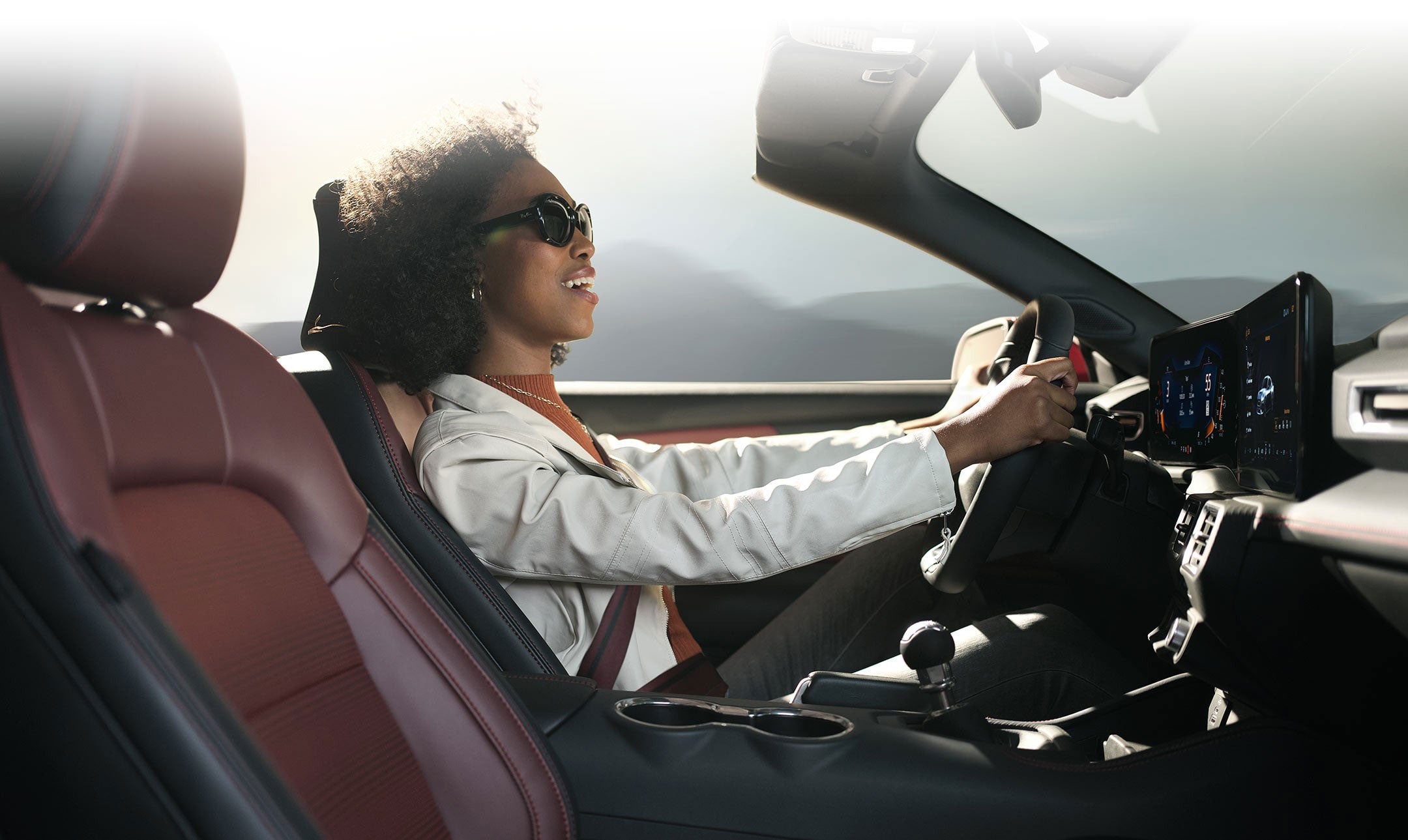 Person sitting in the driver’s seat of a 2024 Ford Mustang® convertible | Pfeifle Ford in Wishek ND