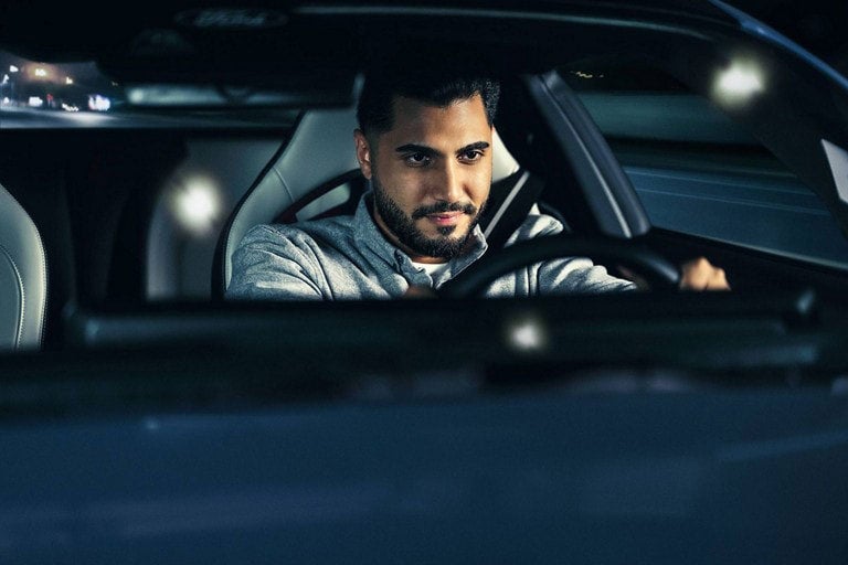 Person sitting in the driver’s seat of a parked 2024 Ford Mustang® coupe | Pfeifle Ford in Wishek ND