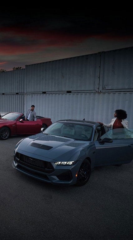 Two people exiting their parked 2024 Ford Mustang® coupe and convertible | Pfeifle Ford in Wishek ND